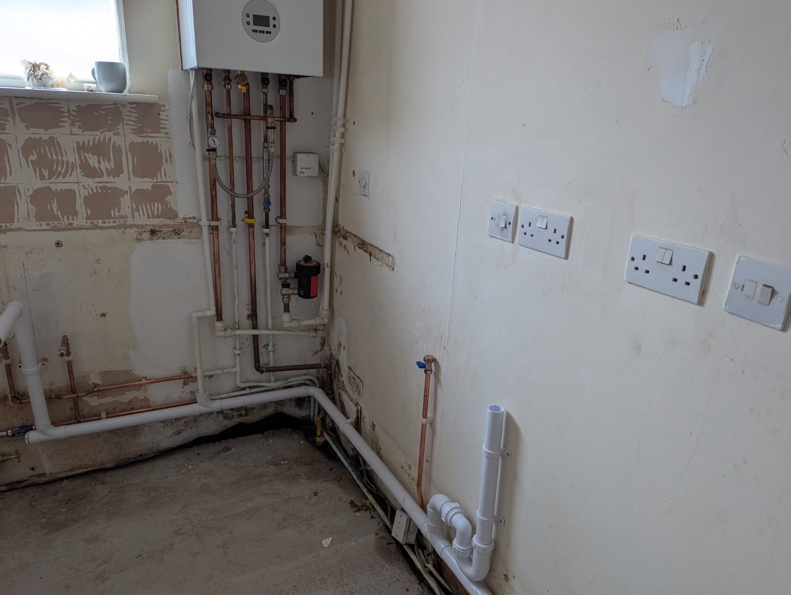 New combi boiler installed with neat copper pipework and a magnetic system filter