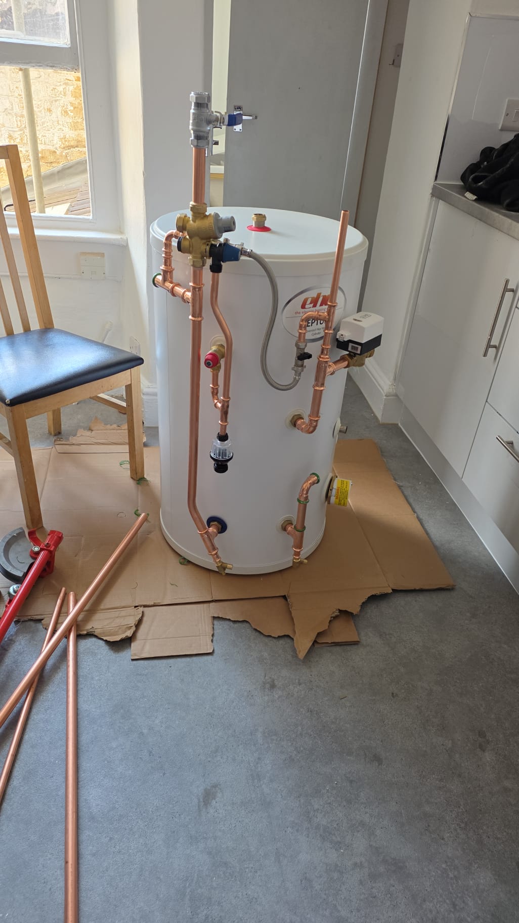 Unvented hot water cylinder installed with new copper pipework, tempering valve and motorised zone valve